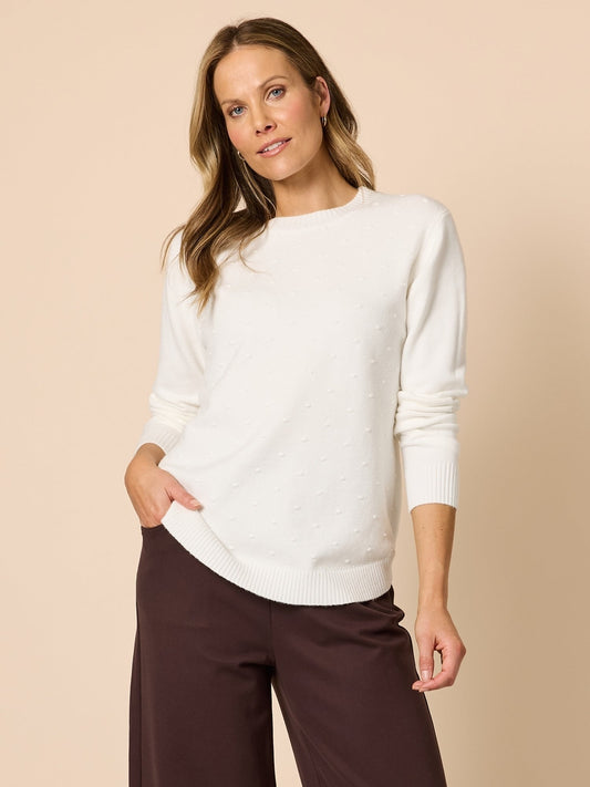 Image of a model wearing Tops. Product name - Alpine Spot Knit Winter White in Winter White colour by brand - Clarity