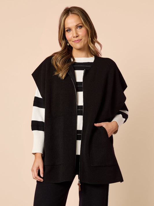 Image of a model wearing Tops. Product name - Elena Zip Knit Black in Black colour by brand - Hammock & Vine