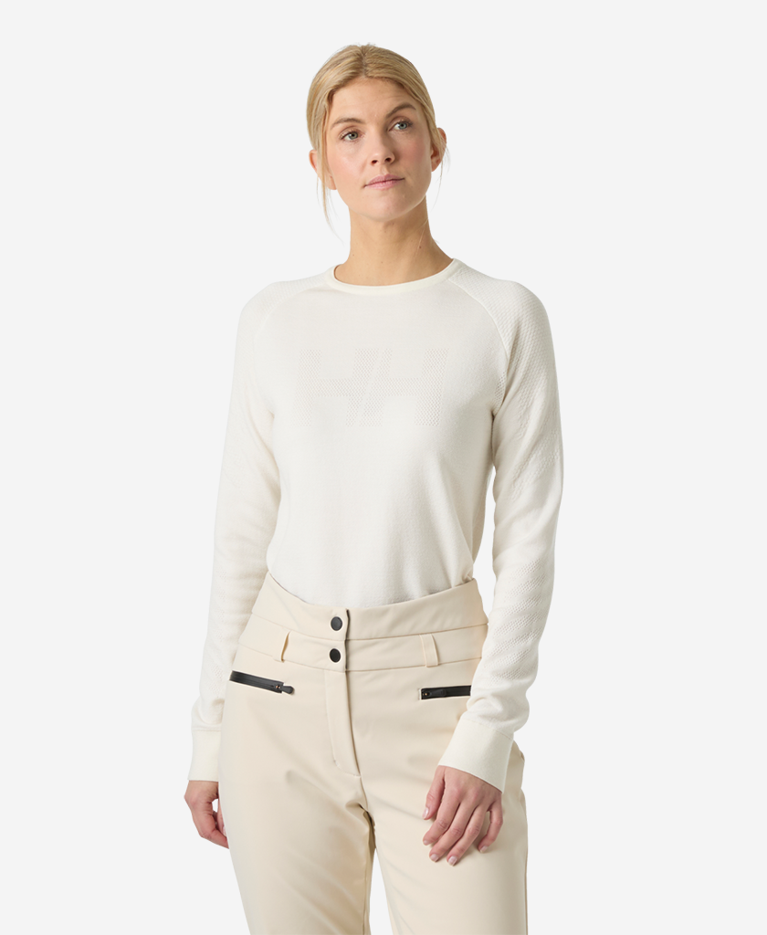 Image of a model wearing Tops. Product name - W LIFA MERINO KNITEVO CREW, Snow in Snow colour by brand - Helly Hansen