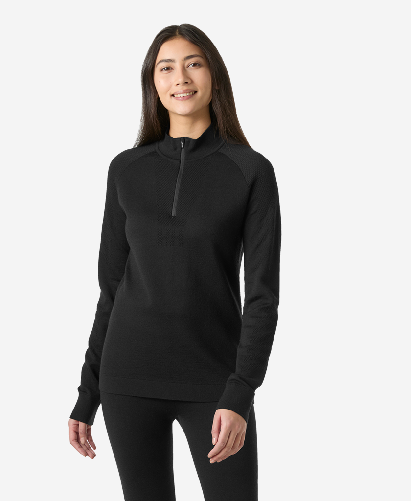 Image of a model wearing Tops. Product name - W LIFA MERINO KNITEVO 1/2 ZIP, Black in Black colour by brand - Helly Hansen