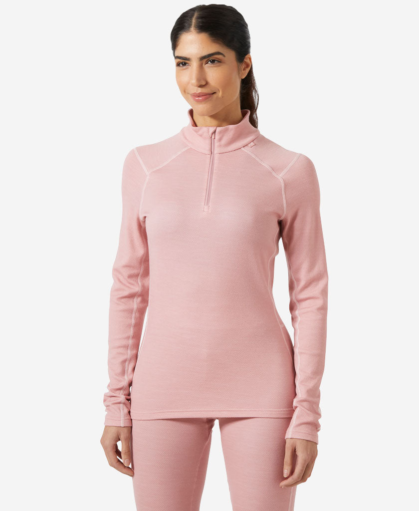 Image of a model wearing Tops. Product name - W LIFA MERINO MIDWEIGHT 1/2 ZIP, Pink Salt in Pink Salt colour by brand - Helly Hansen