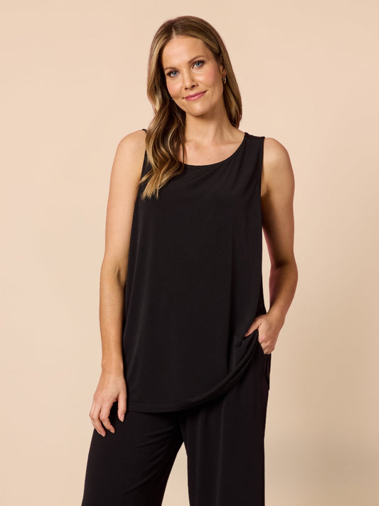 Image of a model wearing Tops. Product name - Traveller Cami Top Black in Black colour by brand - Clarity