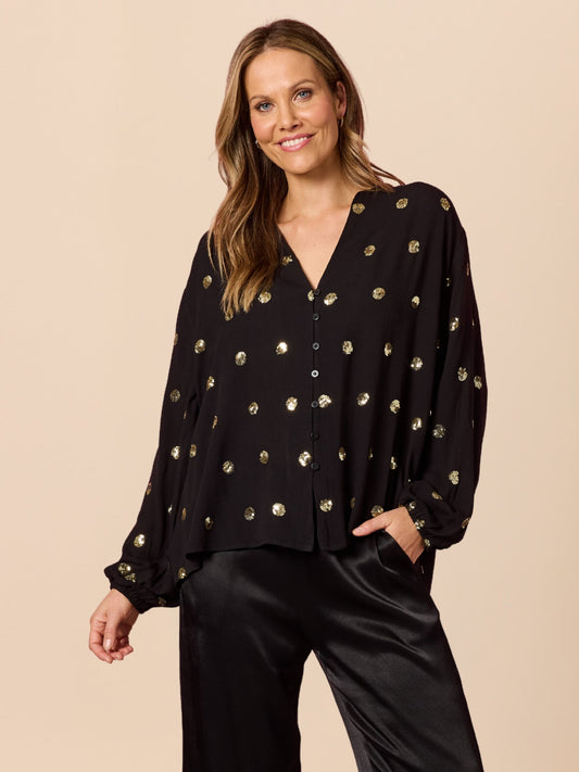 Image of a model wearing Tops. Product name - Allegra Sequin Spot Top Black in Black colour by brand - Hammock & Vine