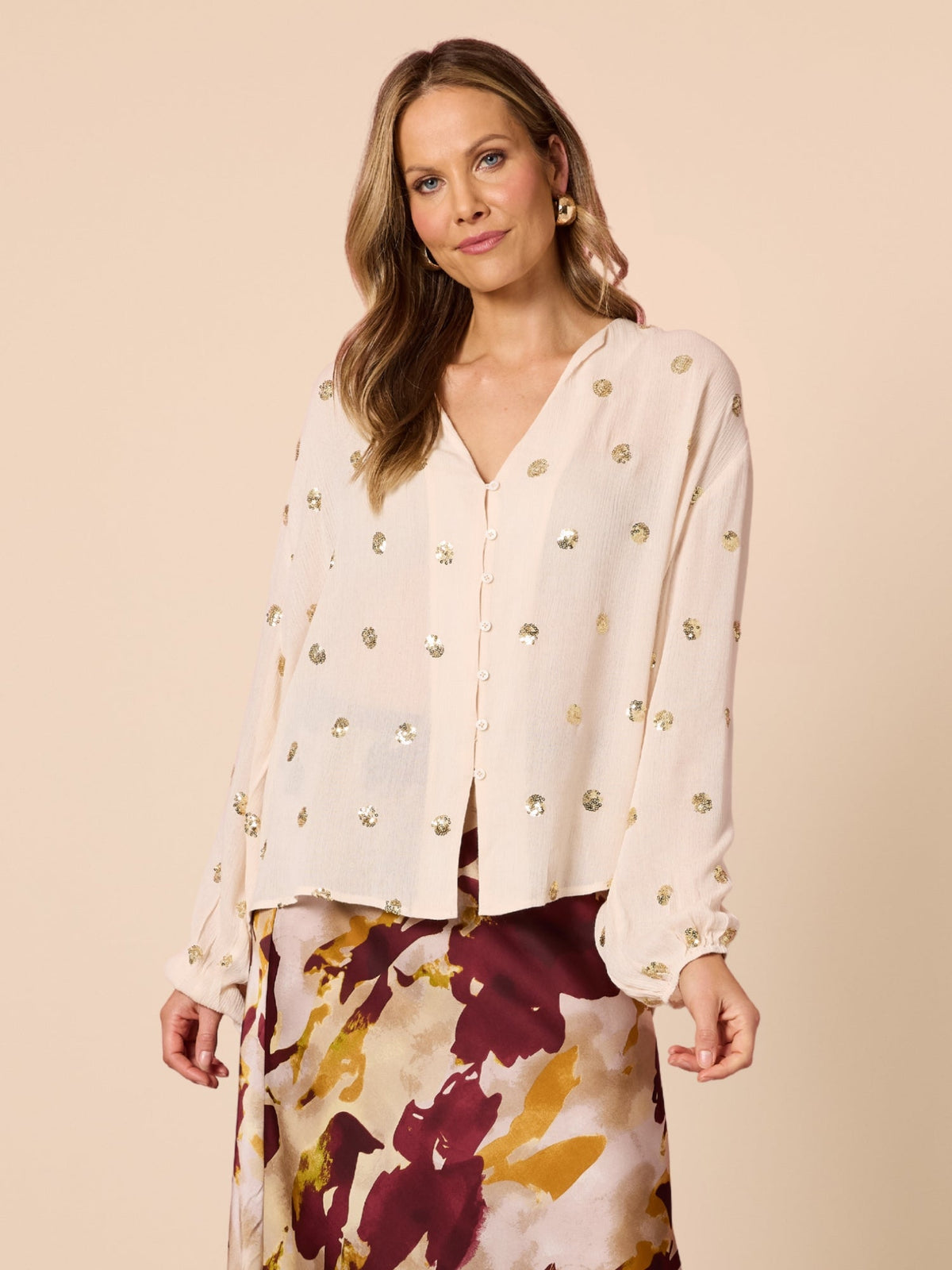 Image of a model wearing Tops. Product name - Allegra Sequin Spot Top Ivory in Ivory colour by brand - Hammock & Vine