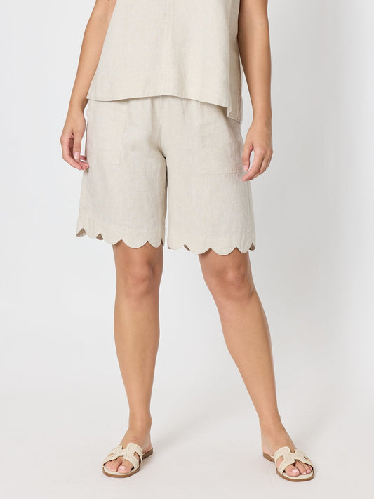 Image of a model wearing Shorts. Product name - Shelley Scallop Hem Linen Short Natural in Natural colour by brand - Gordon Smith