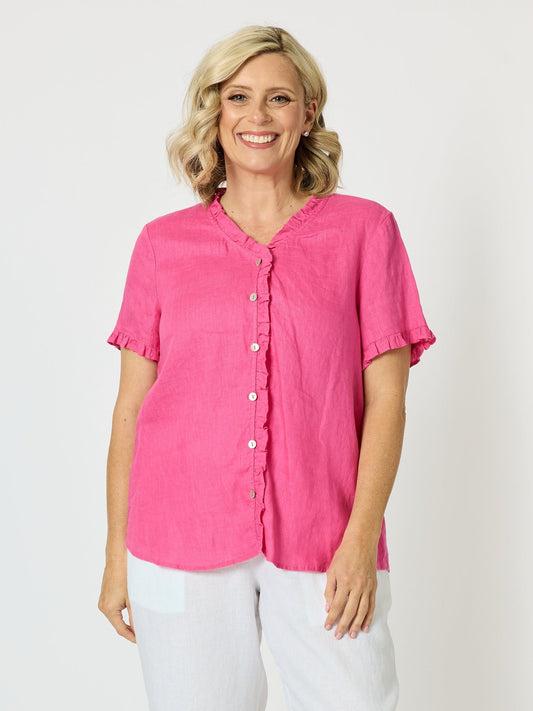 Image of a model wearing Tops. Product name - Audrey Linen Short Sleeve Ruffle Shirt Raspberry in Raspberry colour by brand - Gordon Smith