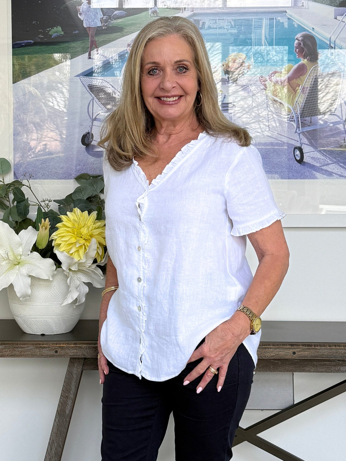 Image of a model wearing Tops. Product name - Audrey Linen Short Sleeve Ruffle Shirt White in White colour by brand - Gordon Smith
