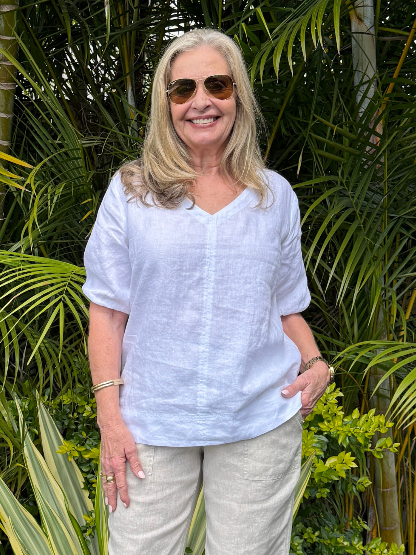 Image of a model wearing Tops. Product name - Anna V-neck Linen Top White in White colour by brand - Gordon Smith
