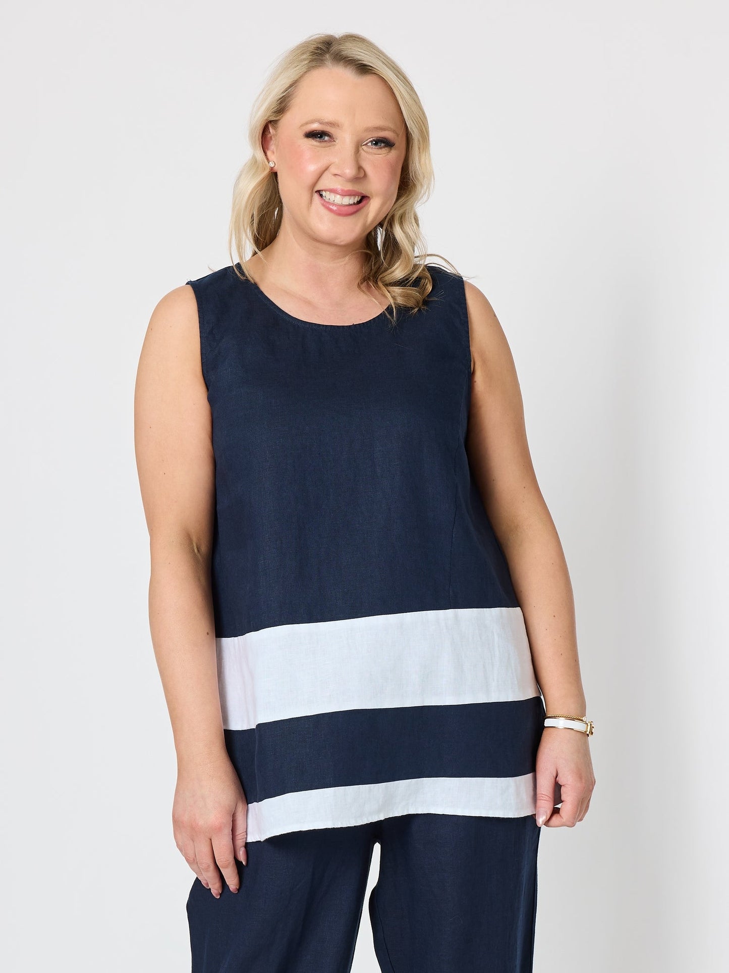 Image of a model wearing Tops. Product name - Chloe Contrast Linen Top Navy/White in Navy/White colour by brand - Gordon Smith