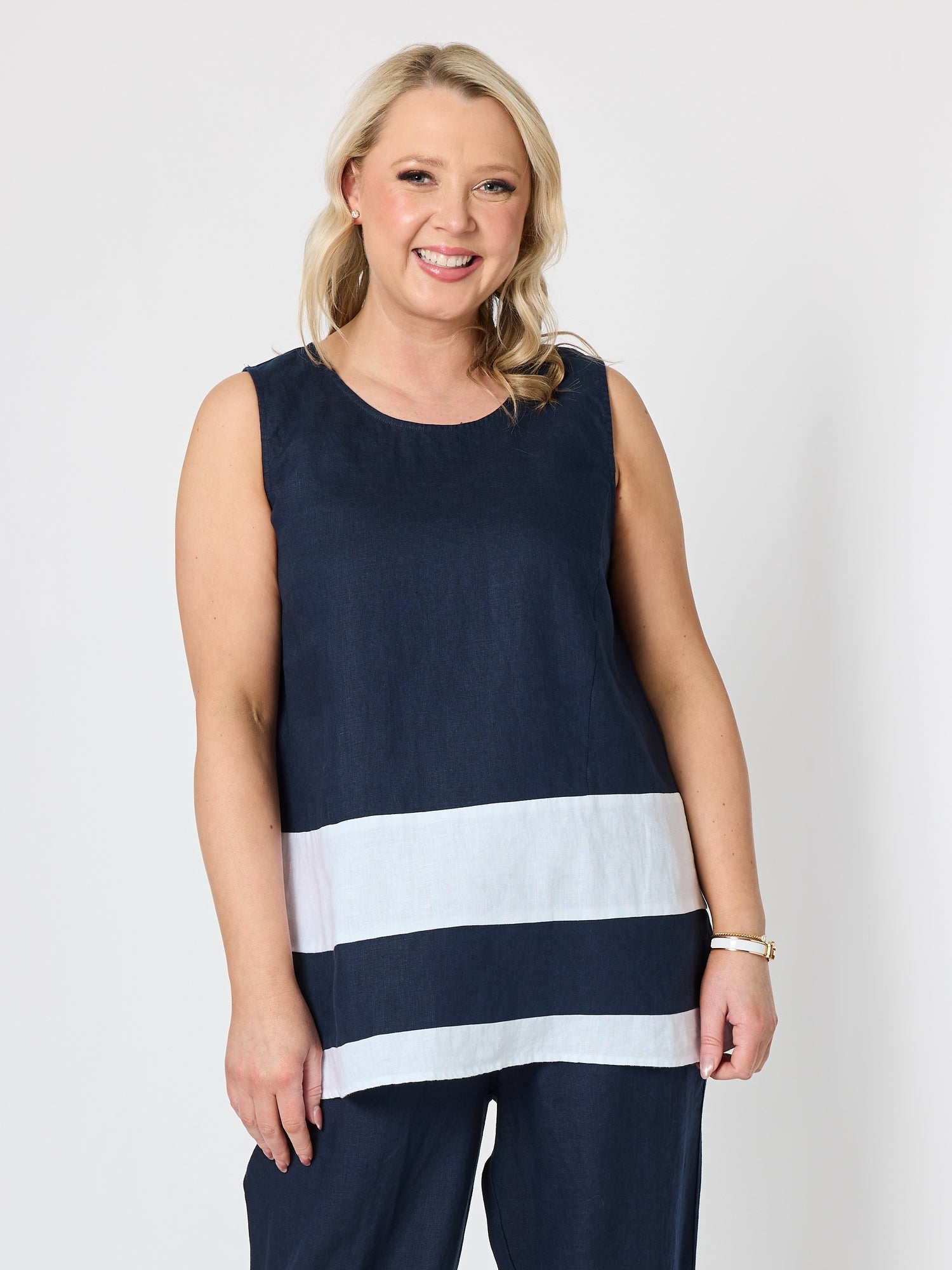 Image of a model wearing Tops. Product name - Chloe Contrast Linen Top Navy/White in Navy/White colour by brand - Gordon Smith