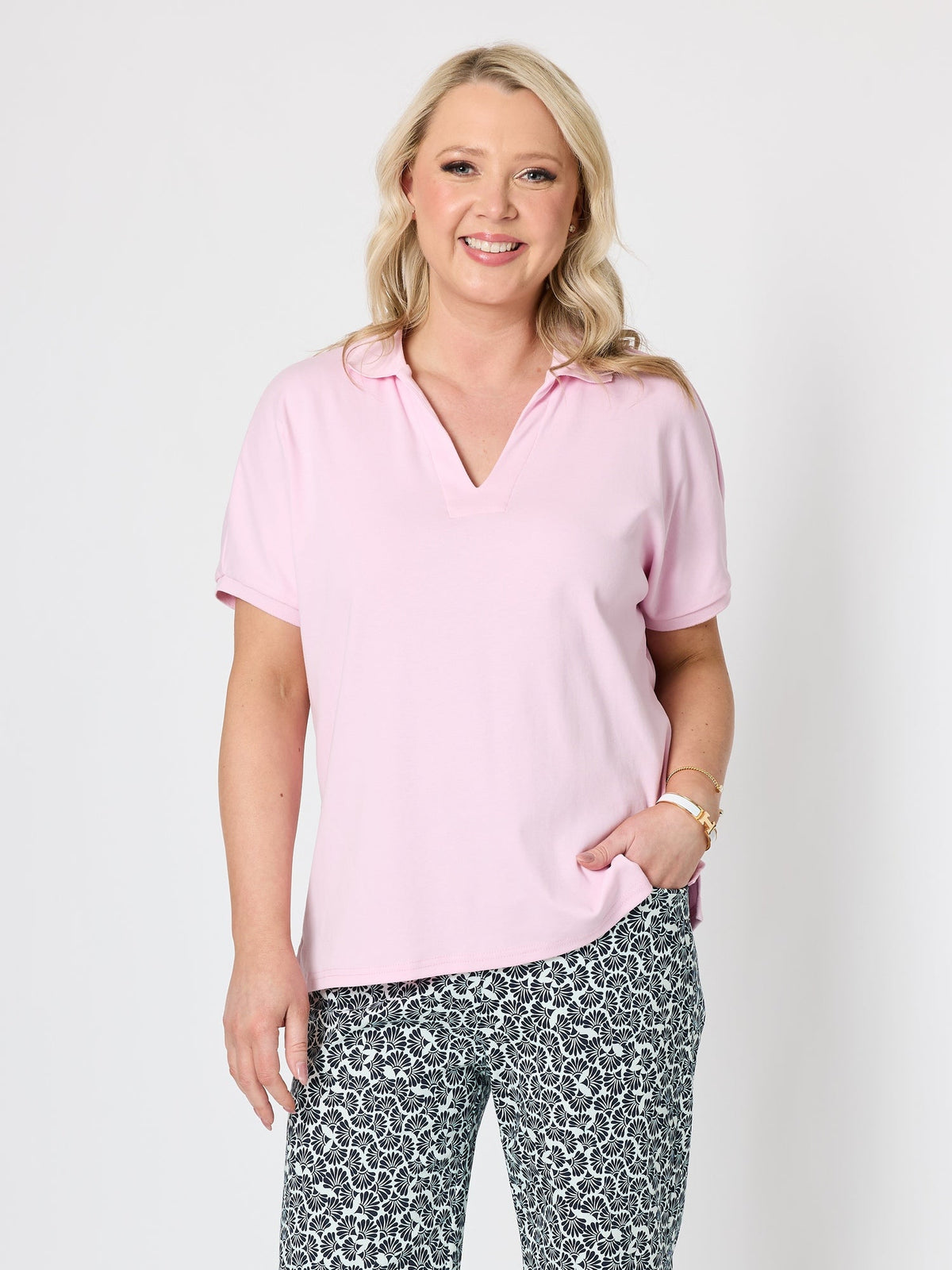 Image of a model wearing Tops. Product name - Fairway Polo Top Pink in Pink colour by brand - Gordon Smith