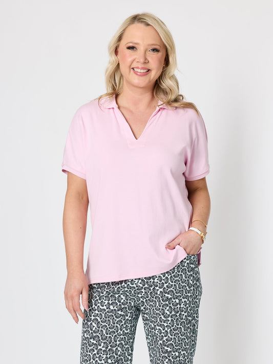 Image of a model wearing Tops. Product name - Fairway Polo Top Pink in Pink colour by brand - Gordon Smith