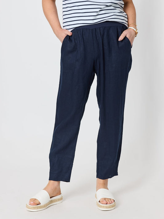 Image of a model wearing Pants. Product name - Sarah Linen Pleat Hem Pant Navy in Navy colour by brand - Gordon Smith
