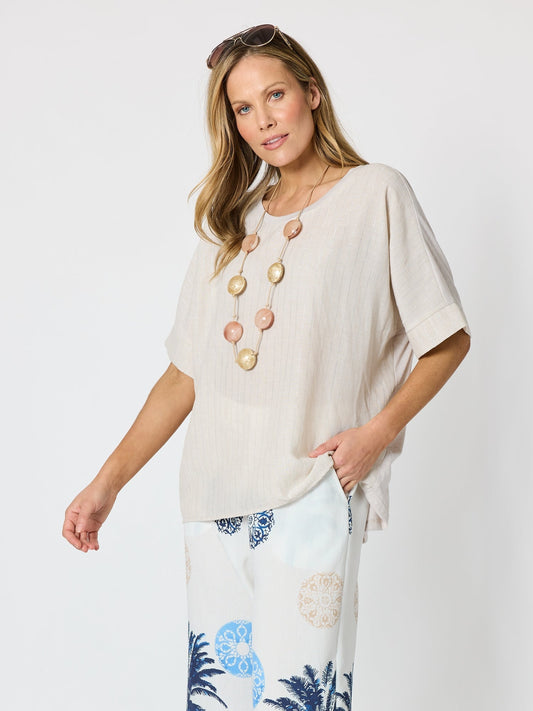 Image of a model wearing Tops. Product name - Riviera Relaxed Stripe Top Natural in Natural colour by brand - Clarity
