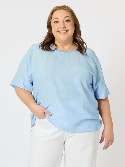 Image of a model wearing Tops. Product name - Riviera Relaxed Stripe Top Pale Blue in Pale Blue colour by brand - Clarity
