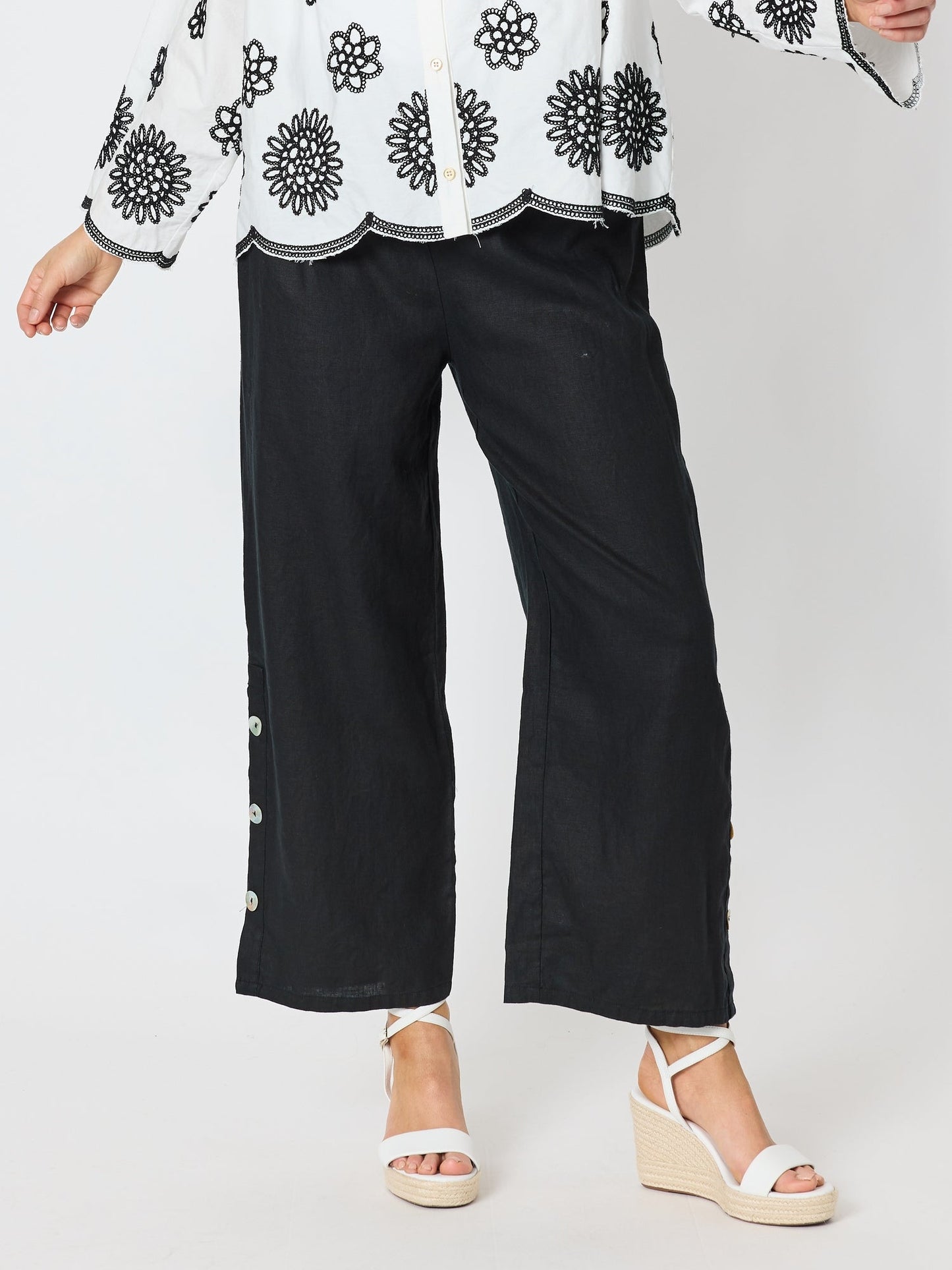 Image of a model wearing Pants. Product name - Bayview Wide Leg Linen Pant Black in Black colour by brand - Hammock & Vine