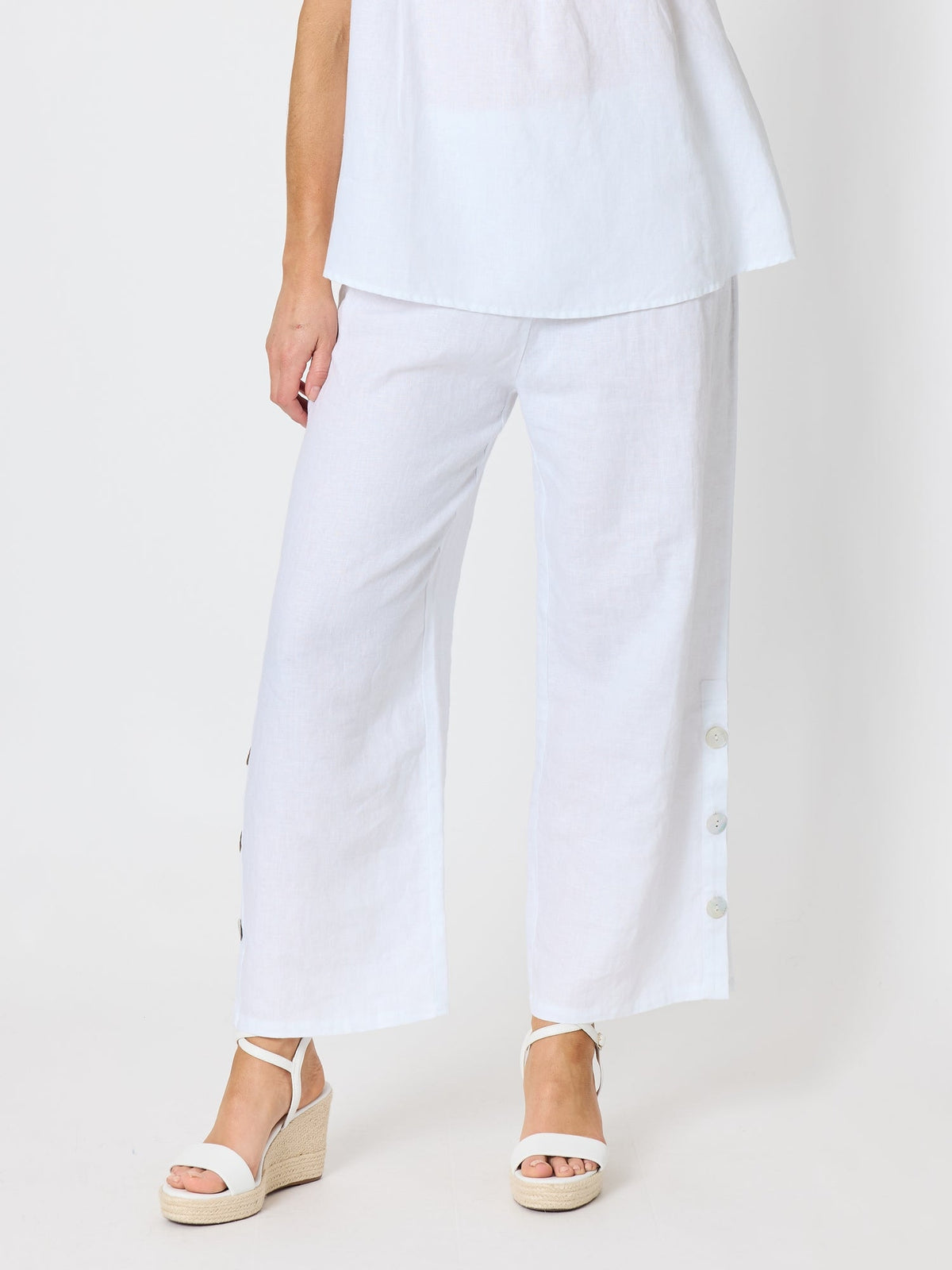 Image of a model wearing Pants. Product name - Bayview Wide Leg Linen Pant White in White colour by brand - Hammock & Vine