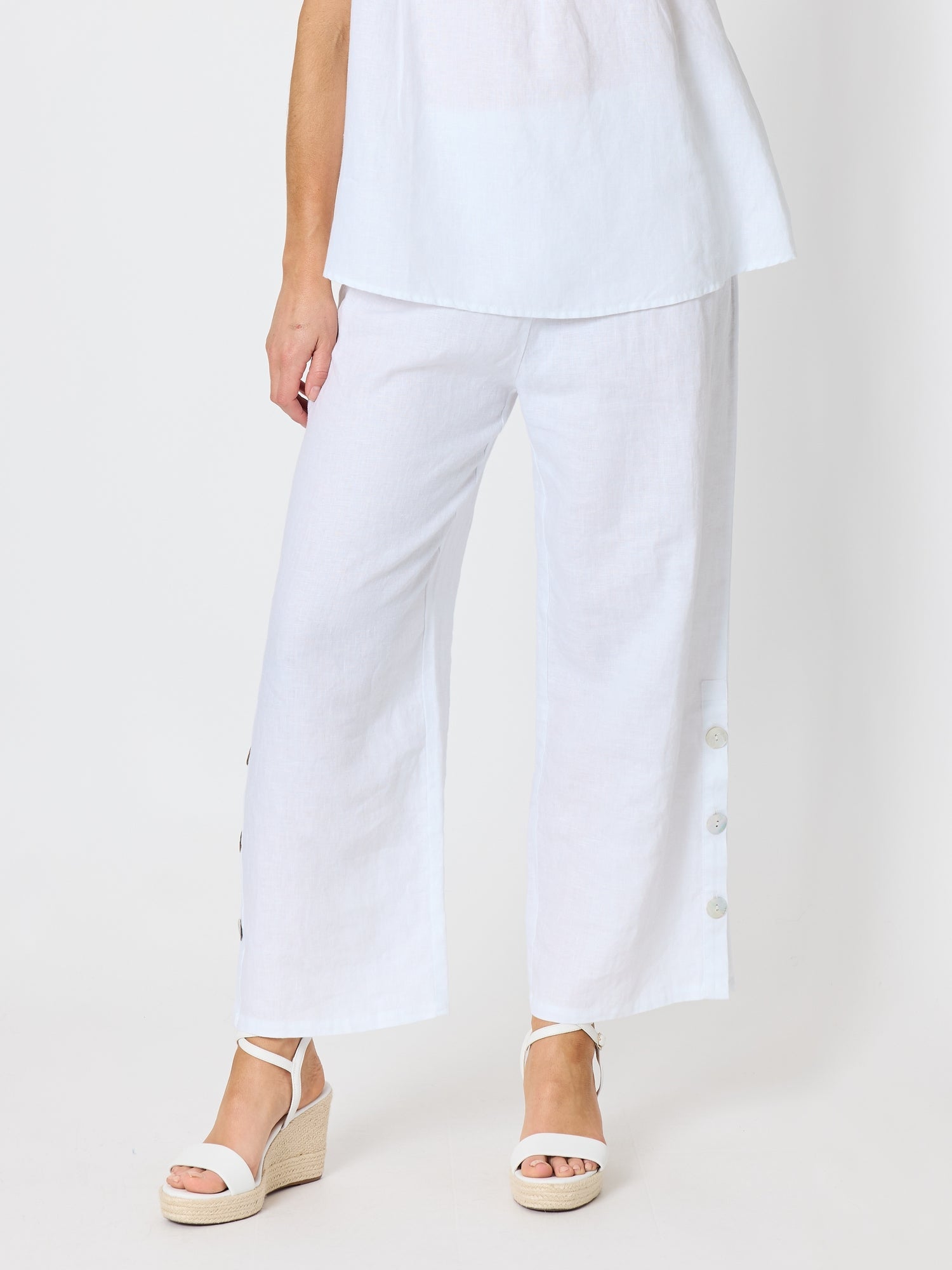 Image of a model wearing Pants. Product name - Bayview Wide Leg Linen Pant White in White colour by brand - Hammock & Vine