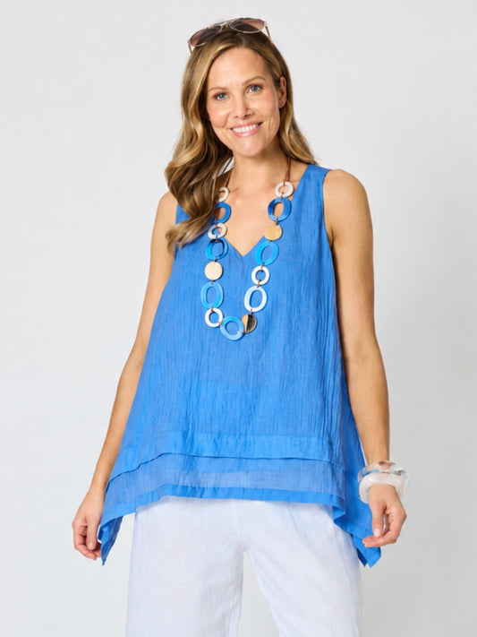 Image of a model wearing Tops. Product name - Essential Layer Cami Azure in Azure colour by brand - Clarity