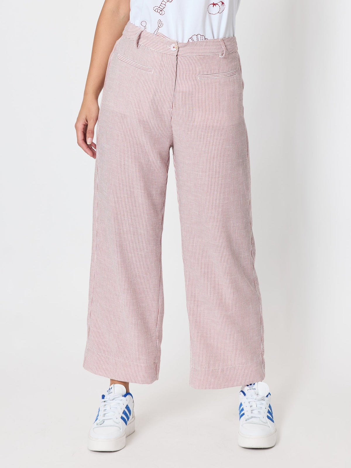 Image of a model wearing Pants. Product name - City Stripe Print Straight Leg Pant Red White in Red White colour by brand - Threadz