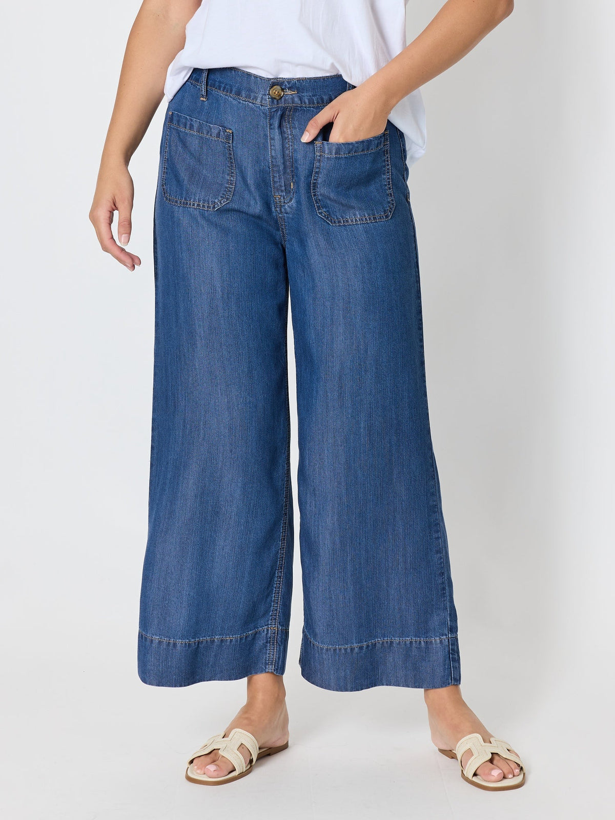 Image of a model wearing Pants. Product name - Dune Carpenter Wide Leg Cropped Pant Dark Denim in Dark Denim colour by brand - Threadz