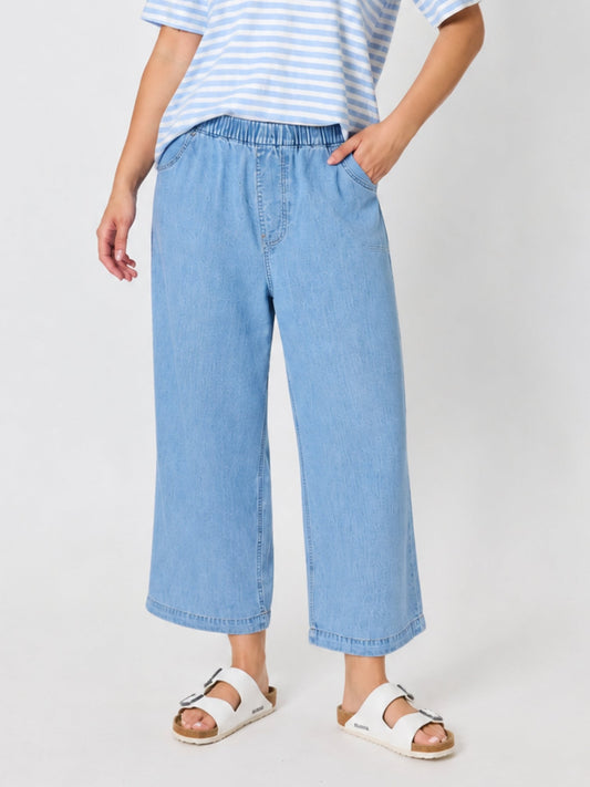Image of a model wearing Pants. Product name - Seaview Chambray Pant Denim in Denim colour by brand - Threadz