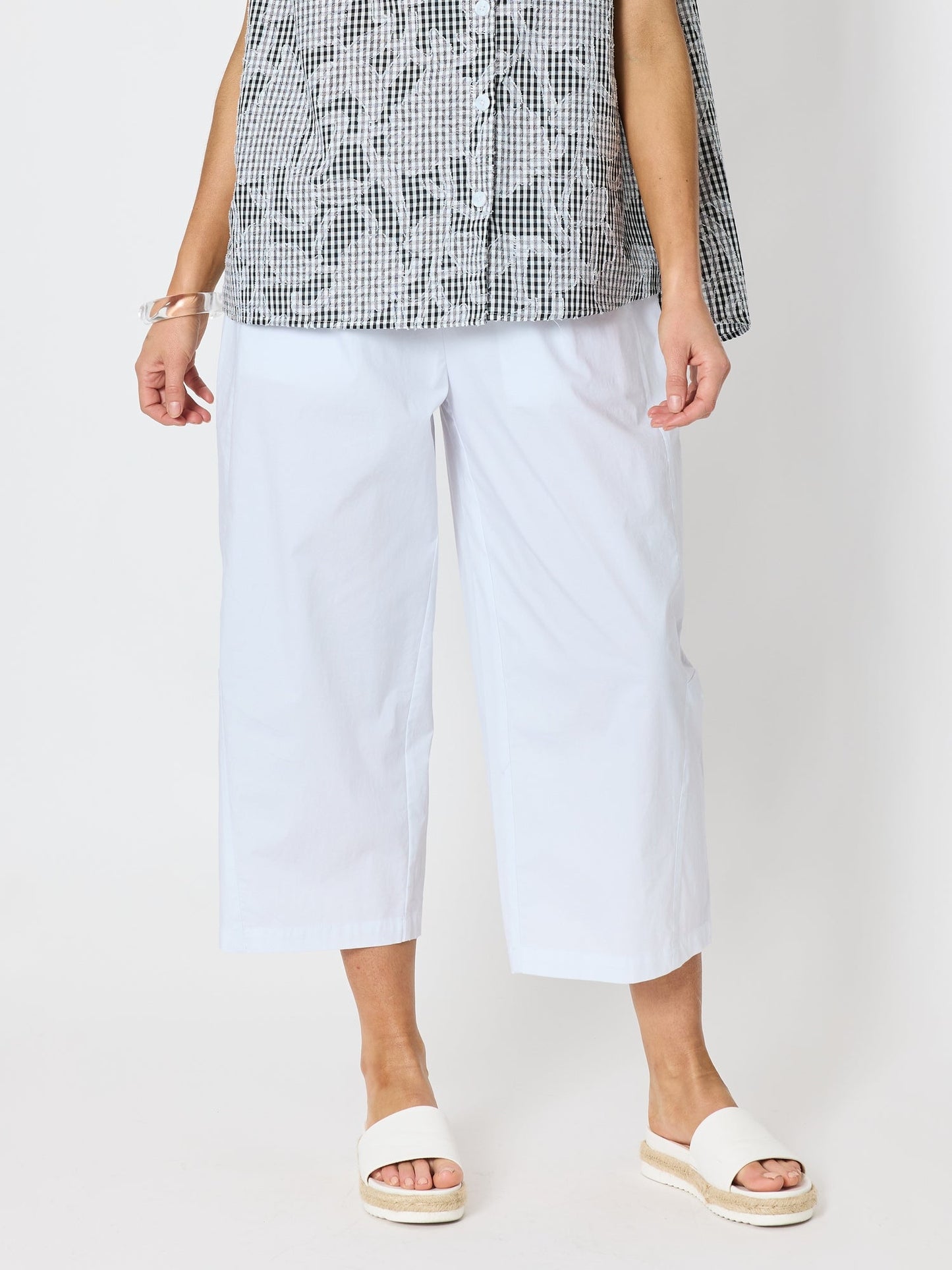 Image of a model wearing Pants. Product name - Toledo Parachute Crop Pant White in White colour by brand - Clarity