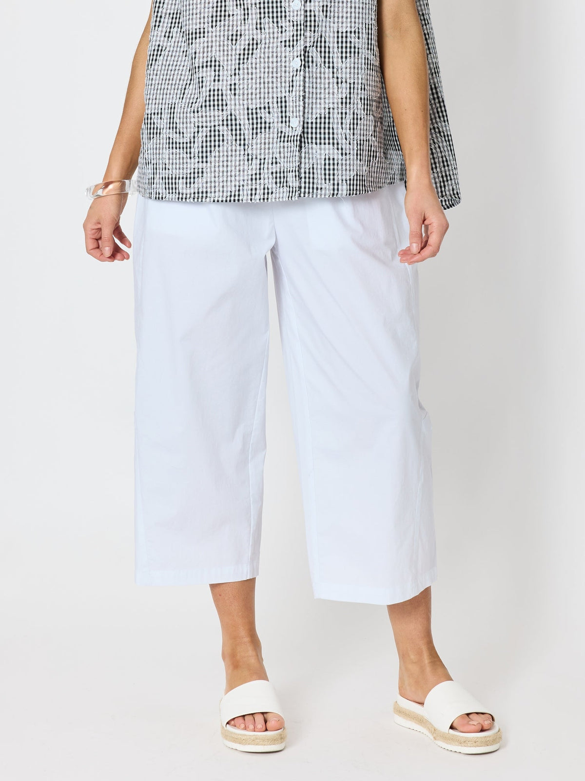 Image of a model wearing Pants. Product name - Toledo Parachute Crop Pant White in White colour by brand - Clarity