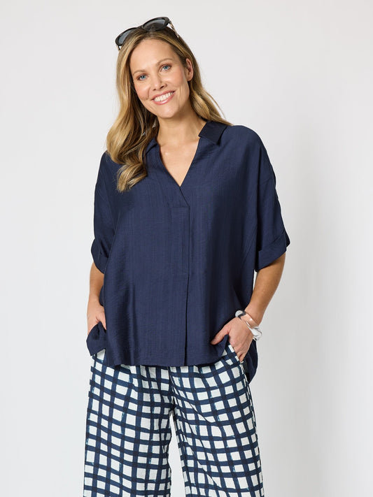 Image of a model wearing Tops. Product name - Del Mar Pleat Detail Top Navy in Navy colour by brand - Clarity