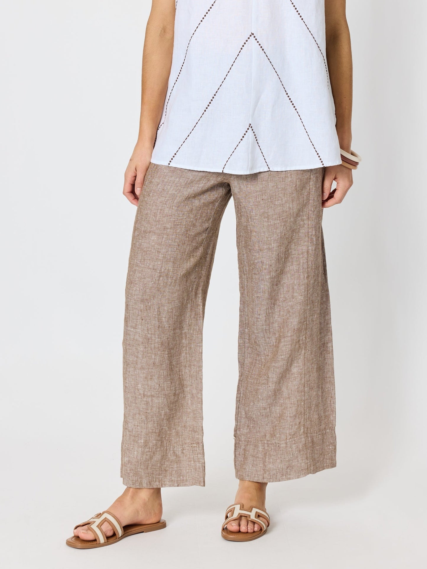 Image of a model wearing Pants. Product name - Haven Linen Wide Leg Pant Mocha in Mocha colour by brand - Hammock & Vine
