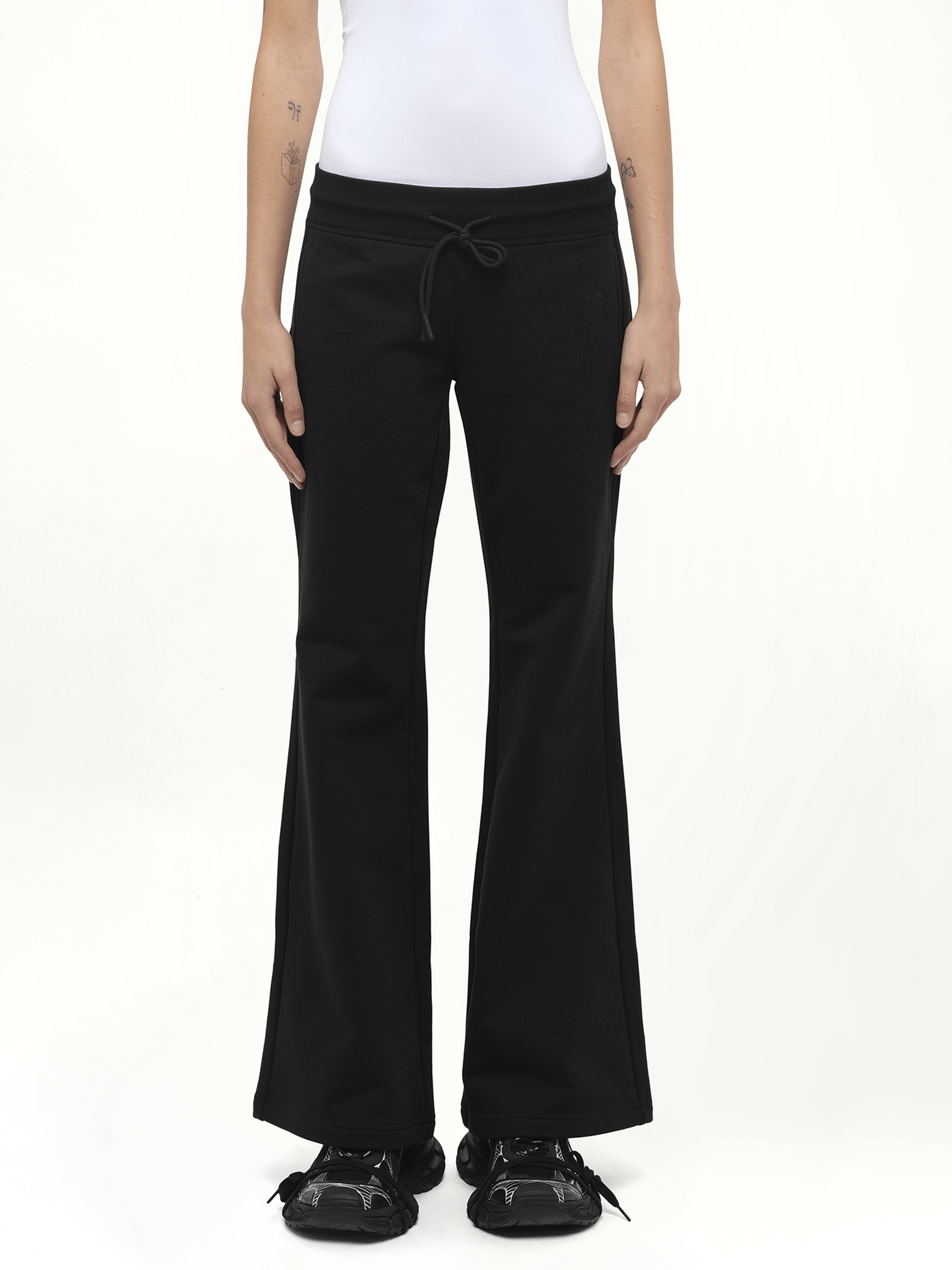 Image of a model wearing Pants. Product name - Casual Flared Sweatpants in Black colour by brand - FAX COPY EXPRESS