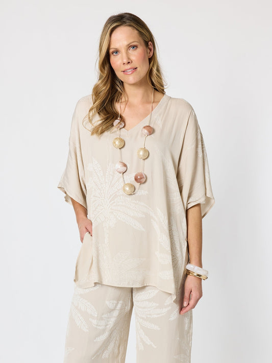 Image of a model wearing Tops. Product name - Sunset Palm Print Top Natural/White in Natural/White colour by brand - Hammock & Vine