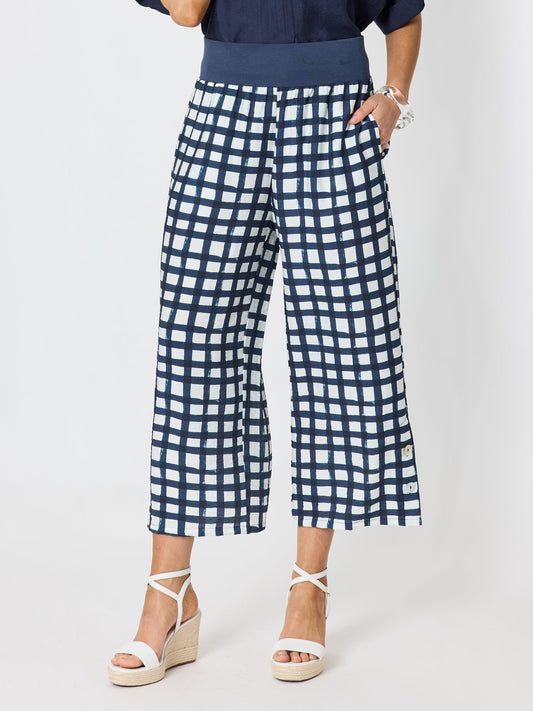 Image of a model wearing Pants. Product name - Monaco Grid Print Wide Leg Pant Navy/White in Navy/White colour by brand - Clarity