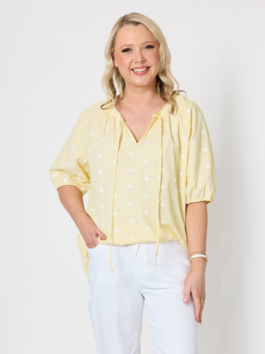 Image of a model wearing Tops. Product name - Monaco Embroidered Spot Top Lemon in Lemon colour by brand - Gordon Smith