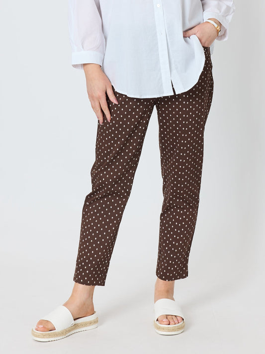 Image of a model wearing Pants. Product name - Shell Print Pant Mocha in Mocha colour by brand - Gordon Smith