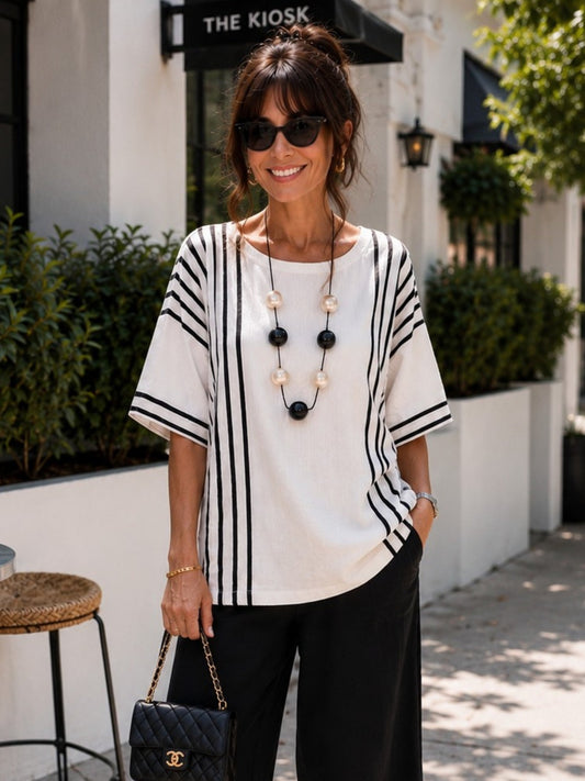 Image of a model wearing Tops. Product name - Sevilla Stripe Top White/Black in White/Black colour by brand - Clarity