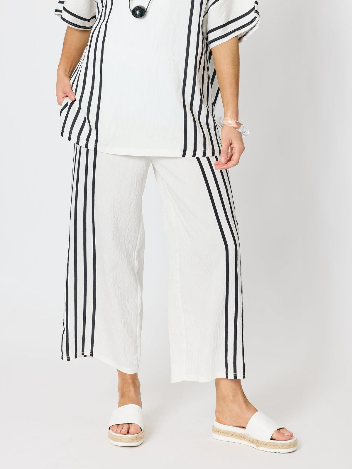 Image of a model wearing Pants. Product name - Sevilla Stripe Print Pant White/Black in White/Black colour by brand - Clarity
