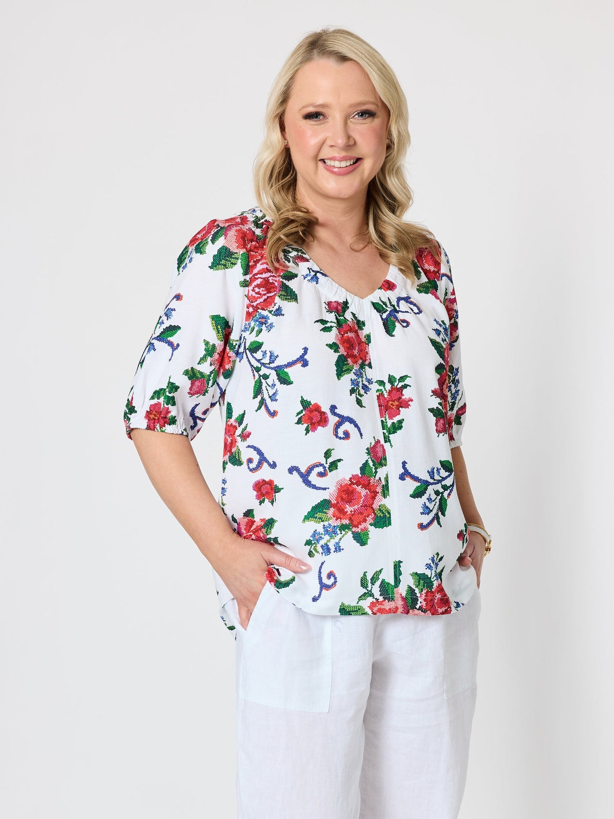 Image of a model wearing Tops. Product name - Fiesta Floral Print Top Rouge Multi in Rouge Multi colour by brand - Gordon Smith