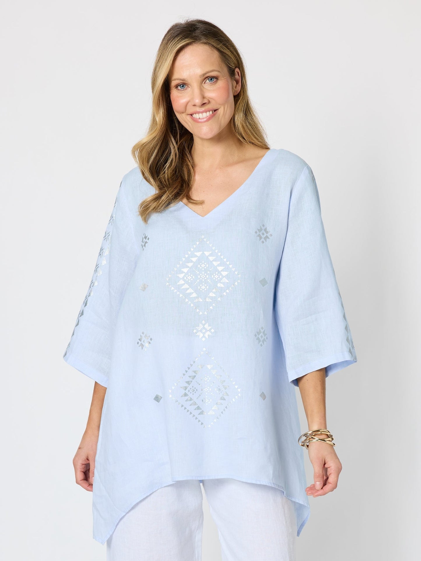 Image of a model wearing Tops. Product name - Soleil Foil Print Linen Top Sky Blue Silver in Sky Blue Silver colour by brand - Hammock & Vine