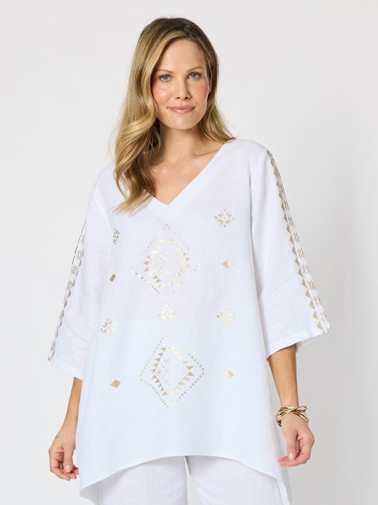 Image of a model wearing Tops. Product name - Soleil Foil Print Linen Top White/Gold in White/Gold colour by brand - Hammock & Vine