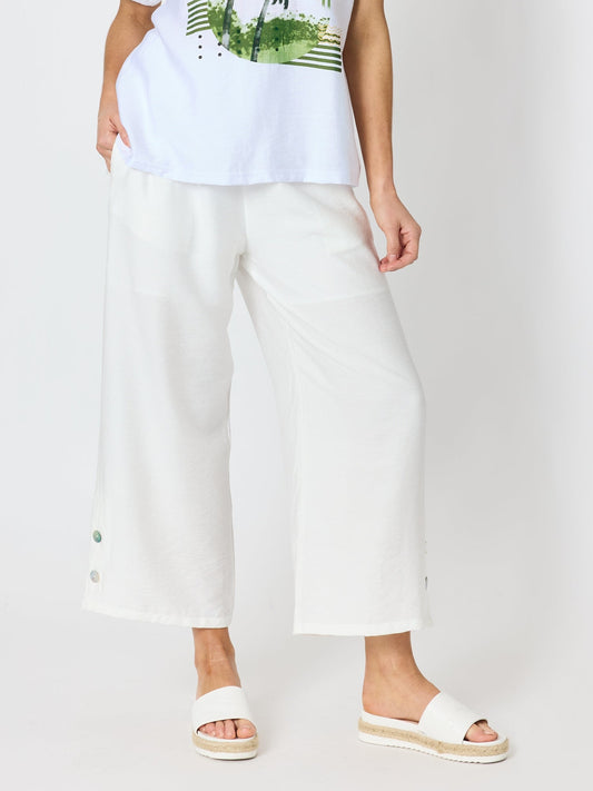 Image of a model wearing Pants. Product name - Essential Button Wide Leg Pant Ivory in Ivory colour by brand - Clarity