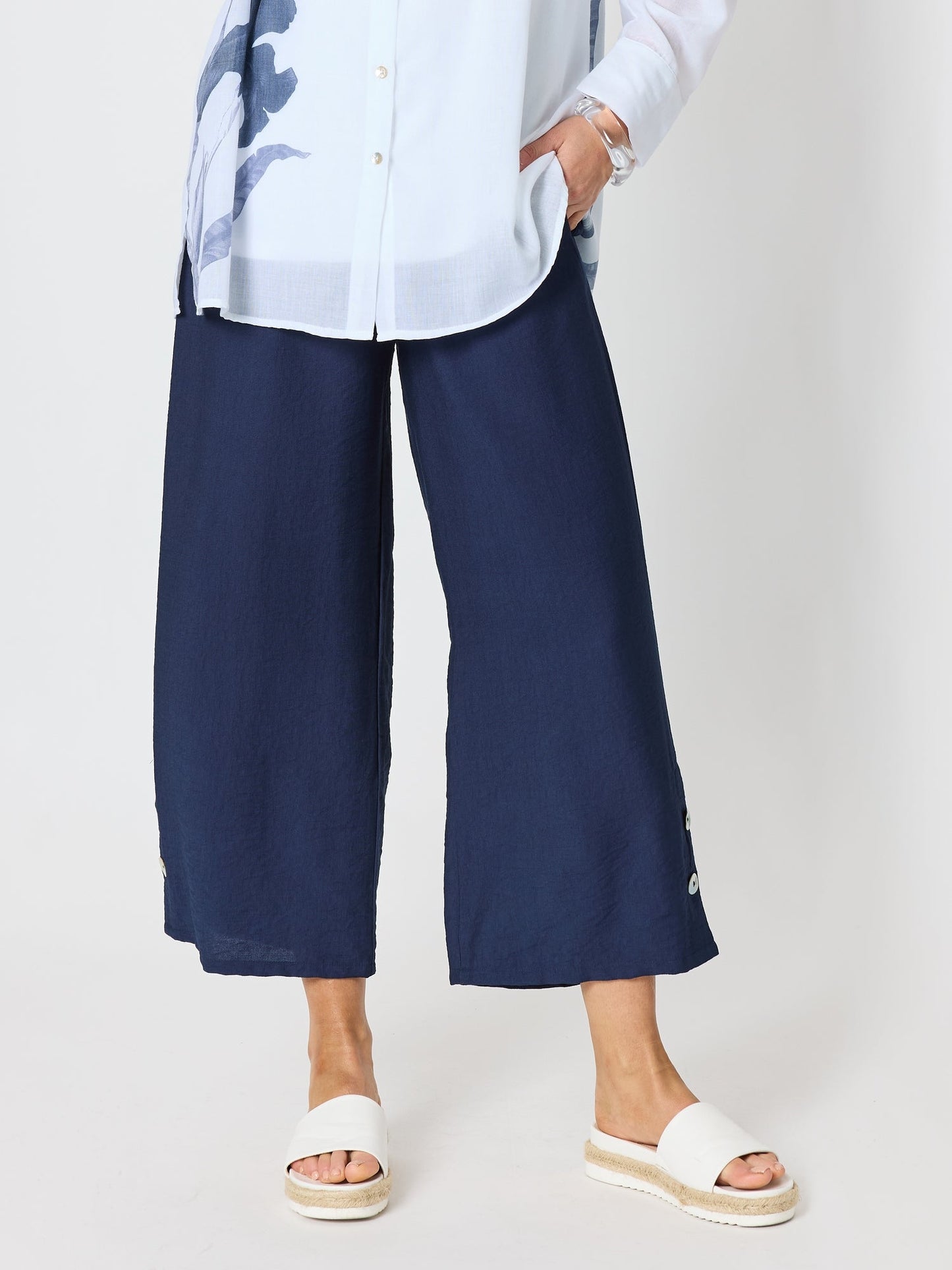 Image of a model wearing Pants. Product name - Essential Button Wide Leg Pant Navy in Navy colour by brand - Clarity
