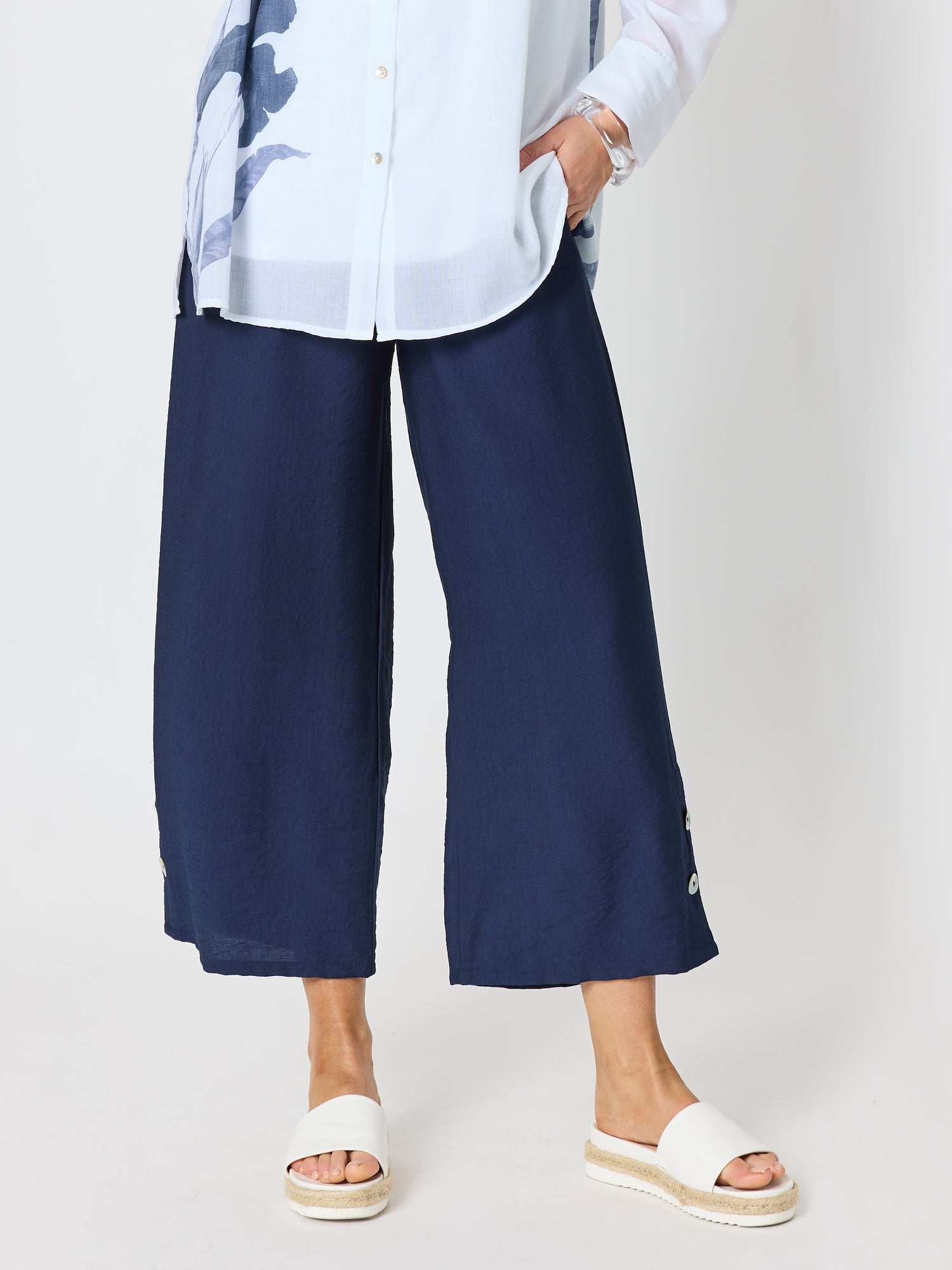 Image of a model wearing Pants. Product name - Essential Button Wide Leg Pant Navy in Navy colour by brand - Clarity