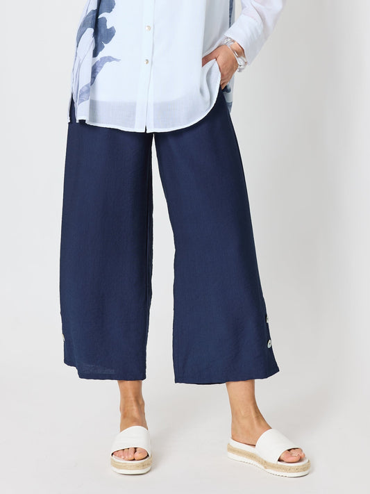 Image of a model wearing Pants. Product name - Essential Button Wide Leg Pant Navy in Navy colour by brand - Clarity