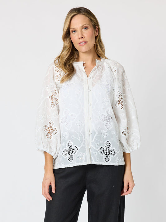 Image of a model wearing Tops. Product name - Carmen Embroidered Lace Top White in White colour by brand - Hammock & Vine