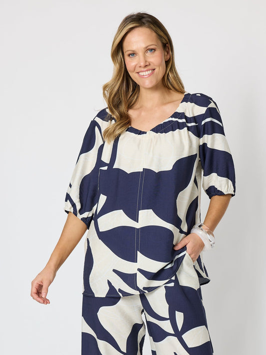 Image of a model wearing Tops. Product name - Bay Leaf Print V Neck Top Navy Multi in Navy Multi colour by brand - Clarity