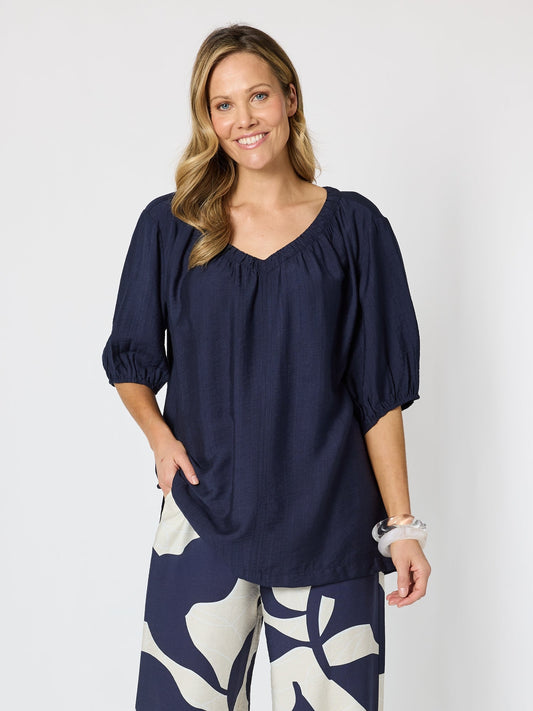 Image of a model wearing Tops. Product name - Marina Bay V Neck Top Navy in Navy colour by brand - Clarity