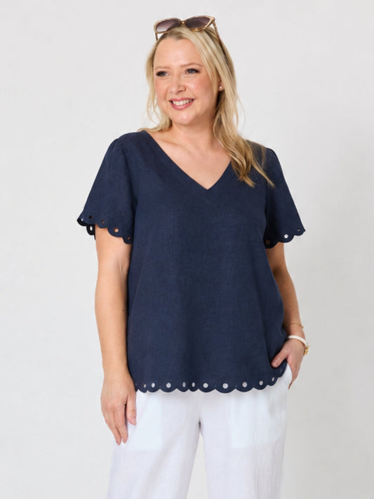 Image of a model wearing Tops. Product name - Lilly Scallop Hem Linen Top Navy in Navy colour by brand - Gordon Smith