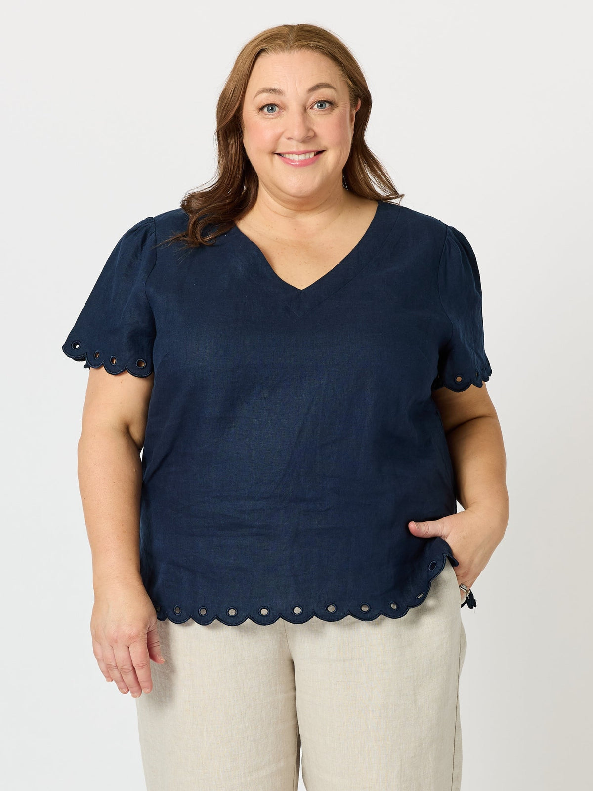 Image of a model wearing Tops. Product name - Lilly Scallop Hem Linen Top Navy in Navy colour by brand - Gordon Smith