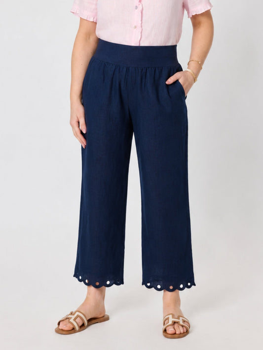 Image of a model wearing Pants. Product name - Lilly Scallop Hem Linen Pant Navy in Navy colour by brand - Gordon Smith